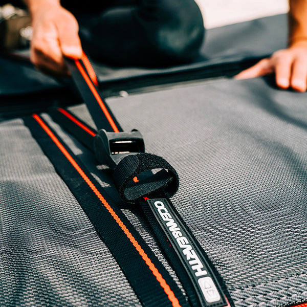 Ocean & Earth Tie Down Straps holding down a surfboard in a board bag.